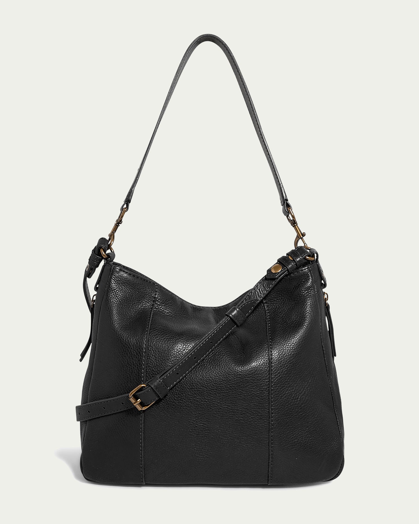 The Austin Convertible Shoulder Crossbody from American Leather Co., in black leather, is showcased against a light background. This stylish bag features stitching details, a front buckle, and practical side zipper pockets for easy access to essentials. It also includes both a long strap and a shorter handle for versatile carrying options.
