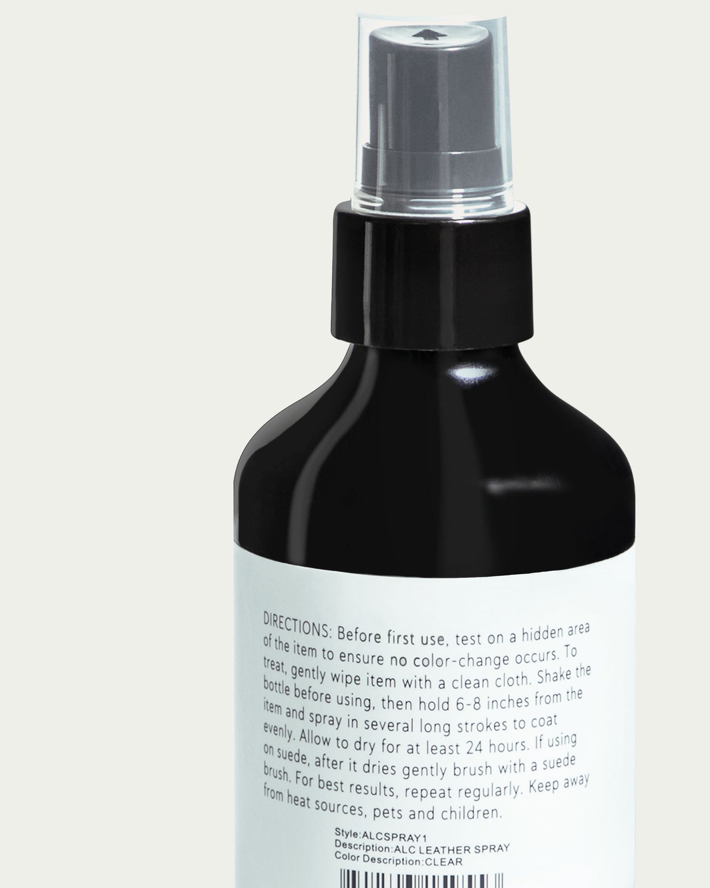 A close-up of the Protect & Treat Premium Leather Protectant Spray by American Leather Co. shows a spray bottle with a black top and white label conveying usage instructions, detailing its leather treatment benefits. The directions stress testing on an inconspicuous area, maintaining distance while spraying, and highlight its effectiveness at repelling water and keeping materials stain resistant.