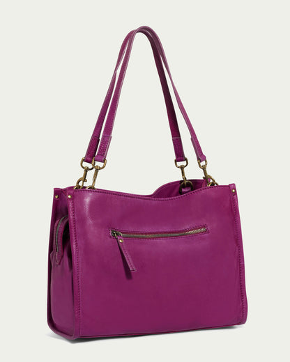 Introducing the Lenox Triple Entry Satchel by American Leather Co., a chic accessory crafted from genuine purple American leather. This satchel includes two shoulder straps and a front zipper pocket, highlighted with elegant gold-tone metal accents. Its minimalist design renders it an everyday essential, perfect against a plain, light background.