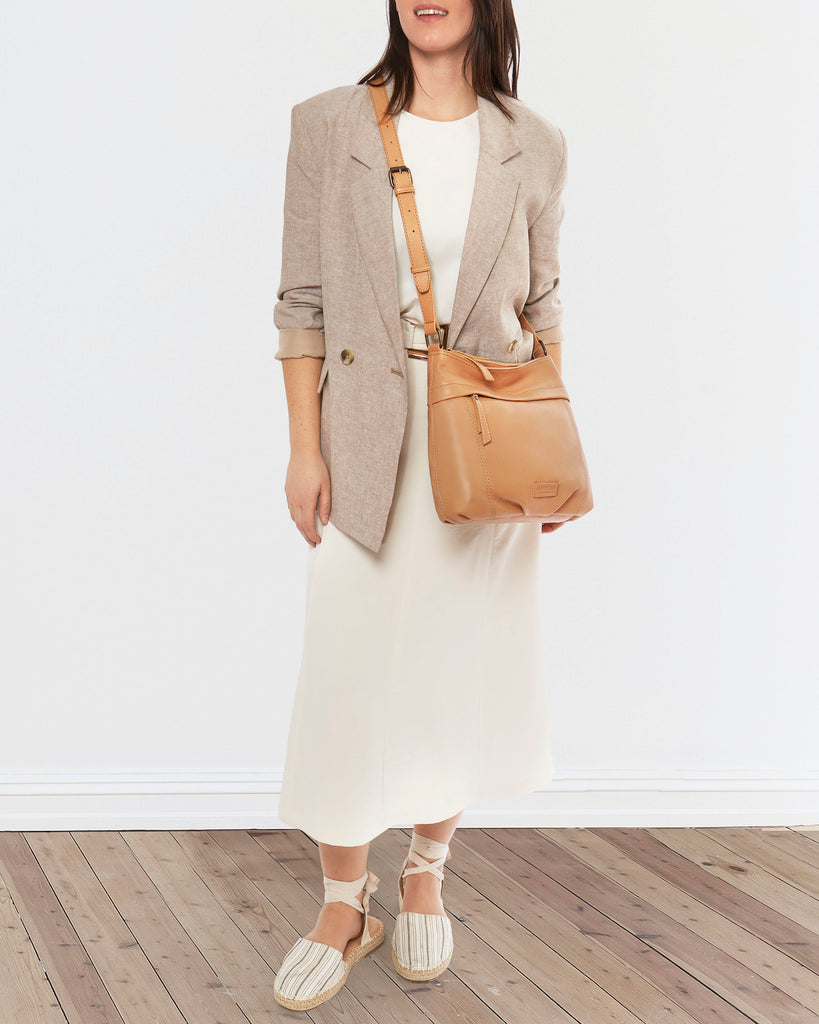 Woman wearing the Acorn Double Entry Leather Crossbody Bag in Cashew from American Leather Co.