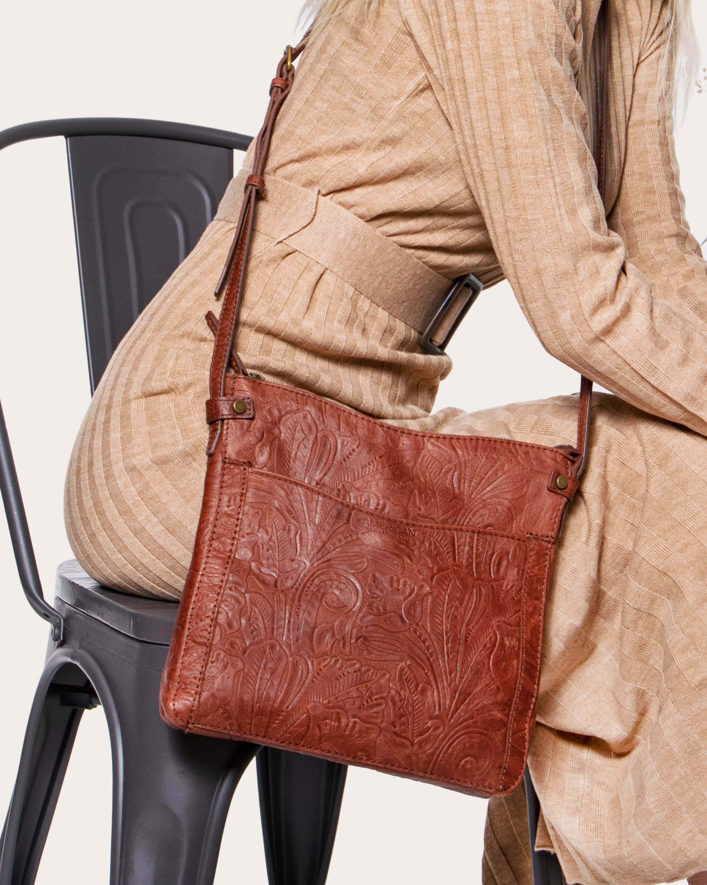 Leather crossbody bag with all-over embossed eagle